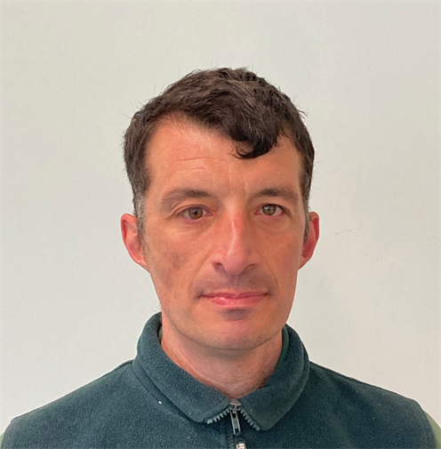Photograph of man with short brown hair wearing a dark green fleece. Photograph of man with short brown hair wearing a dark green fleece.