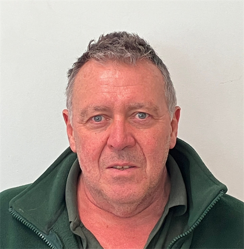 Photograph of a man with short hair in a dark green fleece. Photograph of a man with short hair in a dark green fleece.